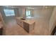 Open concept kitchen with island, stainless steel appliances, and access to living room at 1511 Woodmont Blvd, Kissimmee, FL 34746