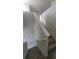 Modern staircase with carpeted steps and neutral-colored walls at 1511 Woodmont Blvd, Kissimmee, FL 34746