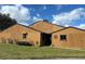 Tan exterior of house with landscaping at 156 Lakewood Village Cir # 156, Daytona Beach, FL 32119