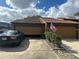 Condo garage with an open garage door and American flag at 156 Lakewood Village Cir # 156, Daytona Beach, FL 32119