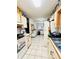 Galley-style kitchen with white cabinets and appliances at 156 Lakewood Village Cir # 156, Daytona Beach, FL 32119