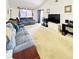 Bright living room featuring a large TV and ample seating at 156 Lakewood Village Cir # 156, Daytona Beach, FL 32119