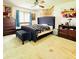 Main bedroom with a large bed, bench, and ample closet space at 156 Lakewood Village Cir # 156, Daytona Beach, FL 32119