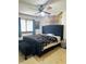 Main bedroom with a large bed, bench, and ample closet space at 156 Lakewood Village Cir # 156, Daytona Beach, FL 32119