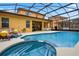 Large, screened-in pool with spa and patio area at 161 Orange Cosmos Blvd, Davenport, FL 33837