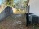 Large backyard with a wooden fence and AC unit at 1823 Natchez Trace Blvd, Orlando, FL 32818