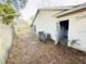 Backyard with mature trees, fence, and access door at 1823 Natchez Trace Blvd, Orlando, FL 32818