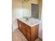 Bathroom vanity with a marble countertop and wooden cabinets, tiled floors at 1823 Natchez Trace Blvd, Orlando, FL 32818