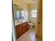 Bathroom featuring tiled floors, a single sink vanity, and a window at 1823 Natchez Trace Blvd, Orlando, FL 32818