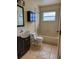 Modest bathroom with a shower and tub combination, vanity and tiled floors at 1823 Natchez Trace Blvd, Orlando, FL 32818