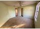 A bedroom with tan carpet, a ceiling fan, and a large closet at 1823 Natchez Trace Blvd, Orlando, FL 32818