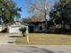 One-story home with a two-car garage and mature trees at 1823 Natchez Trace Blvd, Orlando, FL 32818