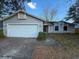 Charming one-story home featuring a two-car garage and well-maintained lawn at 1823 Natchez Trace Blvd, Orlando, FL 32818