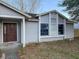 Exterior shot of a home's facade, focusing on the front door and surrounding windows at 1823 Natchez Trace Blvd, Orlando, FL 32818