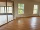 Sun-filled living room with hardwood floors and a sliding glass door to the backyard at 1823 Natchez Trace Blvd, Orlando, FL 32818
