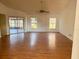 Large living room with hard wood floors, large windows, and sliding doors at 1823 Natchez Trace Blvd, Orlando, FL 32818