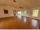 Open living room with hardwood floors and access to the screened-in patio at 1823 Natchez Trace Blvd, Orlando, FL 32818
