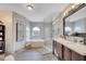 Luxurious bathroom featuring a soaking tub, glass-enclosed shower, and a double vanity with modern fixtures at 212 Rontunda Dr, Kissimmee, FL 34758