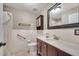 The bathroom features a tiled shower, tiled walls, wood cabinets, and vanity with granite countertop at 212 Rontunda Dr, Kissimmee, FL 34758