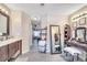 Elegant bathroom featuring a vanity with dark wood cabinets, large mirrors, and stylish decor at 212 Rontunda Dr, Kissimmee, FL 34758