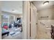 Bathroom and office combo features a toilet, tiled walls and a doorway to an adjacent office space at 212 Rontunda Dr, Kissimmee, FL 34758
