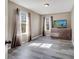 Bedroom featuring wood-look tile floors, neutral walls, and a dresser with a TV on top at 212 Rontunda Dr, Kissimmee, FL 34758