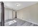 Bedroom featuring wood-look tile floors, neutral walls, a double door closet and ample natural light at 212 Rontunda Dr, Kissimmee, FL 34758