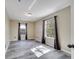 Inviting bedroom with wood-look tile floors, neutral walls, and large windows with curtains at 212 Rontunda Dr, Kissimmee, FL 34758