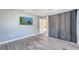 Bedroom with gray walls, wood-look tile floors, a TV, and a view into another room at 212 Rontunda Dr, Kissimmee, FL 34758