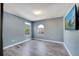 Cozy bedroom with light blue walls, two windows and wood-look tile flooring at 212 Rontunda Dr, Kissimmee, FL 34758