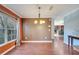 Dining room with hardwood floors, elegant chandelier, views to outside, and access to other rooms at 212 Rontunda Dr, Kissimmee, FL 34758
