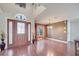 Inviting foyer with hardwood floors, high ceilings, decorative vases, and staircase to the second floor at 212 Rontunda Dr, Kissimmee, FL 34758