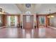 Grand foyer with soaring ceilings, hardwood floors, decorative front door, and views to the outside at 212 Rontunda Dr, Kissimmee, FL 34758