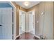 Hallway with hardwood floors leading to two doorways, offering a glimpse into other rooms at 212 Rontunda Dr, Kissimmee, FL 34758