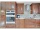 Gourmet kitchen features built-in double ovens, cooktop, and custom cabinetry at 212 Rontunda Dr, Kissimmee, FL 34758