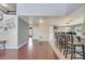 Open concept living and dining rooms offer hardwood floors and neutral walls at 212 Rontunda Dr, Kissimmee, FL 34758