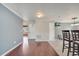Neutral living space with hardwood floors adjacent to kitchen barstool seating at 212 Rontunda Dr, Kissimmee, FL 34758
