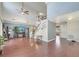 Bright and airy living room featuring a ceiling fan, media center, and staircase to the second floor at 212 Rontunda Dr, Kissimmee, FL 34758