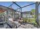 Enclosed patio area with seating, providing a relaxing outdoor space and views of the backyard and pool at 212 Rontunda Dr, Kissimmee, FL 34758