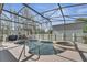 Enclosed backyard pool and hot tub area, surrounded by trees for privacy, ideal for entertaining at 212 Rontunda Dr, Kissimmee, FL 34758