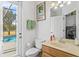 Bathroom with toilet, sink, and access to pool at 2136 Laurel Blossom Cir, Ocoee, FL 34761