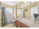 Light yellow bathroom with wood cabinets and bathtub shower combo at 2136 Laurel Blossom Cir, Ocoee, FL 34761