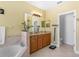 Primary bathroom with bathtub, double vanity, and tiled floor at 2136 Laurel Blossom Cir, Ocoee, FL 34761