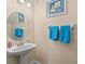 Bathroom with pedestal sink and round mirror at 2136 Laurel Blossom Cir, Ocoee, FL 34761