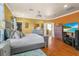 Main bedroom with king-size bed, large TV, and walk-in closet at 2136 Laurel Blossom Cir, Ocoee, FL 34761