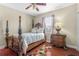 Spacious bedroom with wood flooring and a large four-poster bed at 2136 Laurel Blossom Cir, Ocoee, FL 34761
