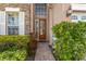 Elegant front door entry with brick walkway and landscaping at 2136 Laurel Blossom Cir, Ocoee, FL 34761