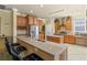 Kitchen with an island, stainless steel appliances, and wood cabinets at 2136 Laurel Blossom Cir, Ocoee, FL 34761