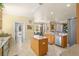 Spacious kitchen with island, stainless steel appliances, and tiled floor at 2136 Laurel Blossom Cir, Ocoee, FL 34761