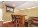 Home bar with wood cabinetry and two stools at 2136 Laurel Blossom Cir, Ocoee, FL 34761